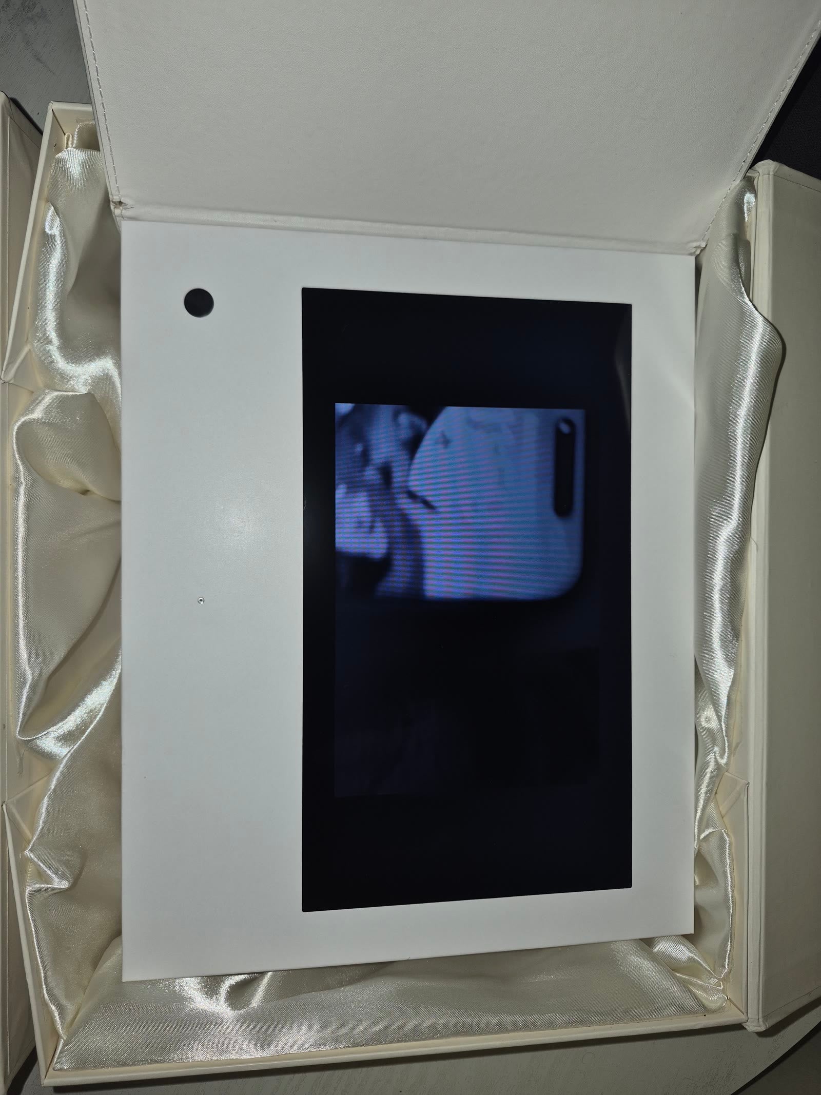 Open cream video book showing its built-in display